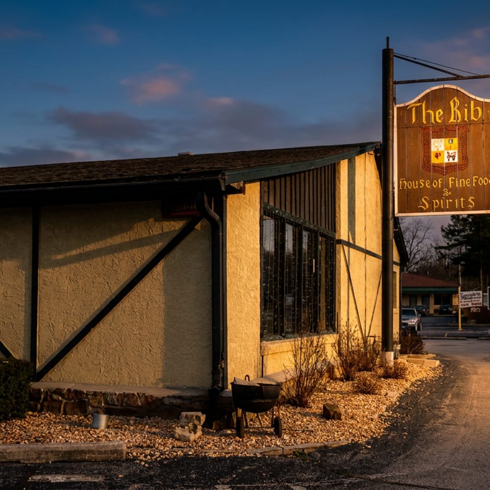 The Bib restaurant exterior at dusk, with a prominent sign and warm light on the building.